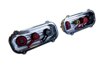 Load image into Gallery viewer, Two billet battery pockets with a silver finish, red switches, and stainless mounting hardware on a textured metal surface.